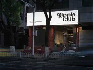 Night view of Ripple Club storefront with illuminated signage, red brick facade, and scooters parked on the street in Taipei.