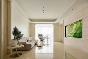 Modern minimalist living room featuring travertine marble walls, a cream modular sofa, a white recliner, and a large green abstract landscape artwork on the right wall.
