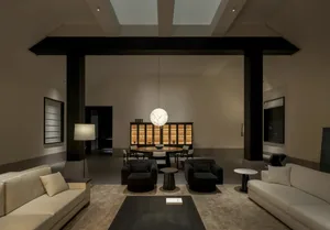 Modern luxury living room featuring dark wooden beams, white sofas, dark armchairs, a large spherical marble pendant light, and an open dining area in the background.