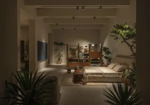 Modern minimalist bedroom with oak wood room divider, neutral linen bedding, abundant indoor plants, and warm track lighting creating a serene atmosphere.