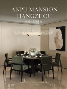 Modern luxury dining room with a round dark wood table surrounded by six sage green velvet dining chairs with black frames, large abstract painting on the wall, and a modern pendant light.