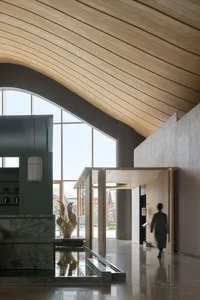 Modern minimalist lobby with dramatic curved wooden ceiling, green stone water feature, large arched windows, and a person walking through the space.
