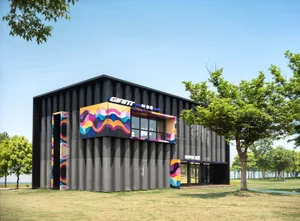 Modern black corrugated metal building featuring large, colorful pop-art wave murals in pink, orange, blue and yellow, surrounded by green trees on a sunny day.