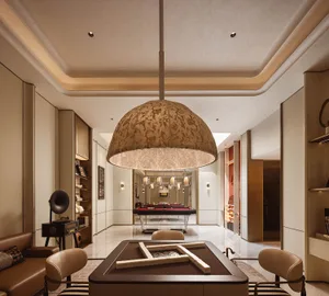 Luxurious modern game room with a large patterned fabric pendant light, walnut mahjong table set with tiles, leather sofa, and a pool table visible in the background.