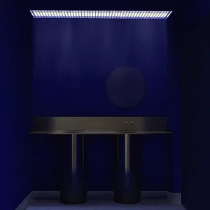 Modern minimalist bathroom featuring a dark concrete double vanity with cylindrical legs, round mirror, and dramatic blue grid ceiling light in an indigo-colored room.