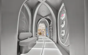 Modern futuristic shoe store interior featuring a long corridor with repeating white gothic arches, illuminated floor tiles, built-in seating, and circular shoe display on the right wall.