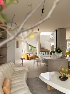 Modern open-concept living room featuring a cream ribbed leather sofa, curved wooden kitchen island, dramatic white spiral staircase, and vibrant yellow furniture in the background.