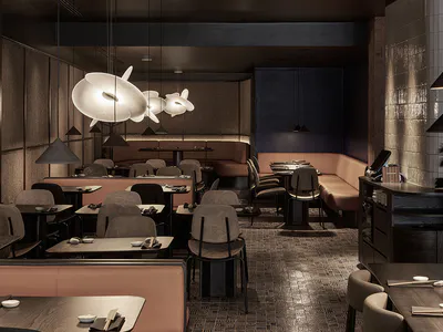 Modern Japanese restaurant interior with dark walnut tables, blush pink banquettes, sculptural white pendant lights, and textured walls.