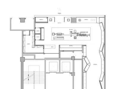 Black and white architectural floor plan of a contemporary retail gallery with curved walls, display areas, fitting rooms, and a staircase.