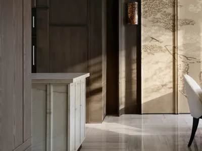 Modern dining area featuring tall dark walnut cabinetry, white marble counter, a tall wall-mounted light fixture, and two large sliding doors with traditional Chinese pine tree ink-wash paintings, paired with a white upholstered dining chair.