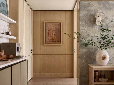Modern minimalist entryway with light oak built-in cabinetry, marble countertops, sculptural wavy ceiling, framed forest artwork, and a console table with botanical wallpaper and a large white vase with green branches.