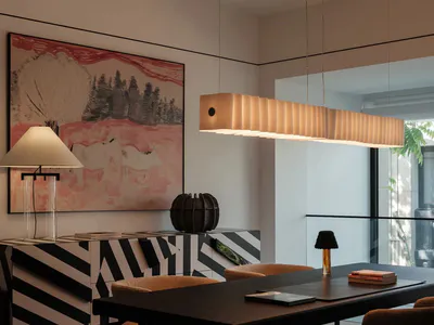Modern dining room with dark wood table, mustard velvet chairs, black and white striped sideboard, large abstract landscape painting, and a long rectangular Akari-style pendant light.