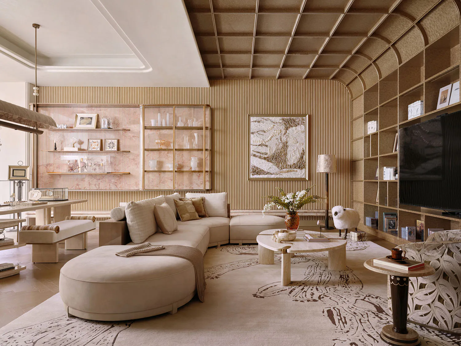 Modern luxury living room with a large beige curved sectional sofa, travertine coffee table, built-in arched bookshelves, and textured beige walls under a coffered ceiling.