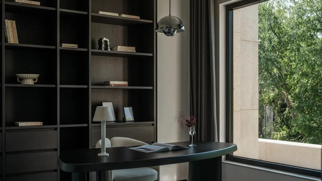 Modern home office featuring dark wood built-in bookshelves, a curved black desk, upholstered chair, pendant light, and a large window with green tree views.