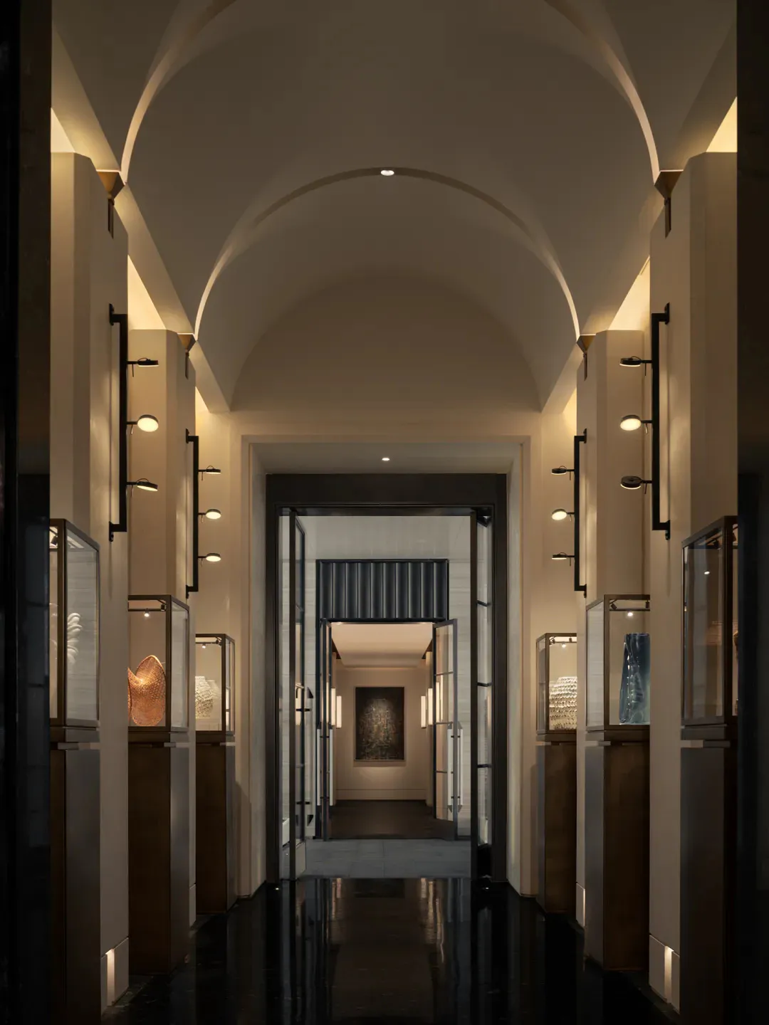 Long symmetrical hallway in a contemporary art gallery with vaulted arched ceiling, polished dark marble floor, and illuminated glass display cases containing sculptural art pieces.