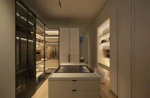 Modern luxury walk-in closet with white matte cabinetry, central glass island, built-in LED lighting, and organized clothing storage.