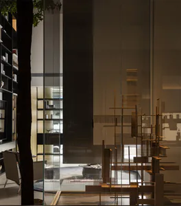 Modern living room featuring a large sculptural oak room divider, floor-to-ceiling glass partition, dark wood bookshelf, and minimalist furniture with warm lighting.