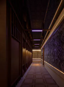 Long narrow luxury wine cellar corridor featuring dark walnut wood cabinetry on the left, textured purple wall covering on the right, and linear purple LED lights recessed in the ceiling.
