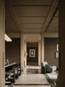 Modern luxury interior hallway with glossy marble floor, dark wood dining chairs, grey armchair, and coffered ceiling.