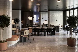 Modern restaurant interior with patterned terrazzo floor, white tiled cylindrical columns, curved brown leather banquette, wooden dining tables, upholstered chairs, potted trees, and sculptural pendant lights.