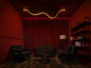 Dark red home theater room featuring black velvet sofas and armchairs, a wavy orange LED light strip on the ceiling, and heavy red velvet curtains.