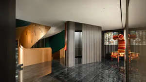 Modern luxury hotel lobby with curved metallic reception desk, dark polished marble floor, hanging pendant lights, and colorful patterned armchairs against abstract art.