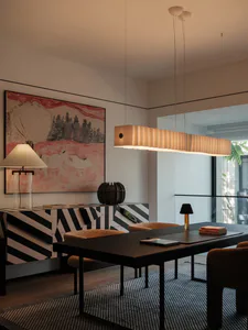 Modern dining room with dark wood table, mustard velvet chairs, black and white striped sideboard, large abstract landscape painting, and a long rectangular Akari-style pendant light.