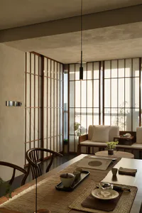 Modern Japanese-style dining room featuring wooden shoji screens, curved wooden dining chairs, a long wooden table with woven placemats, a black pendant light, and a built-in window seat with cushions overlooking bamboo plants.