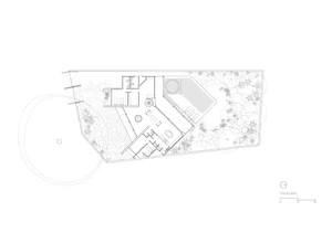 Black and white architectural site plan of a modern villa featuring an irregular-shaped swimming pool, multiple terraces, extensive rock gardens, and lush planting areas with scale indicator.