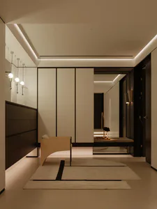 Modern minimalist entryway with white walls, dark walnut cabinetry, a curved light-wood bench, pendant lights, and layered rugs leading to a hallway with built-in seating.